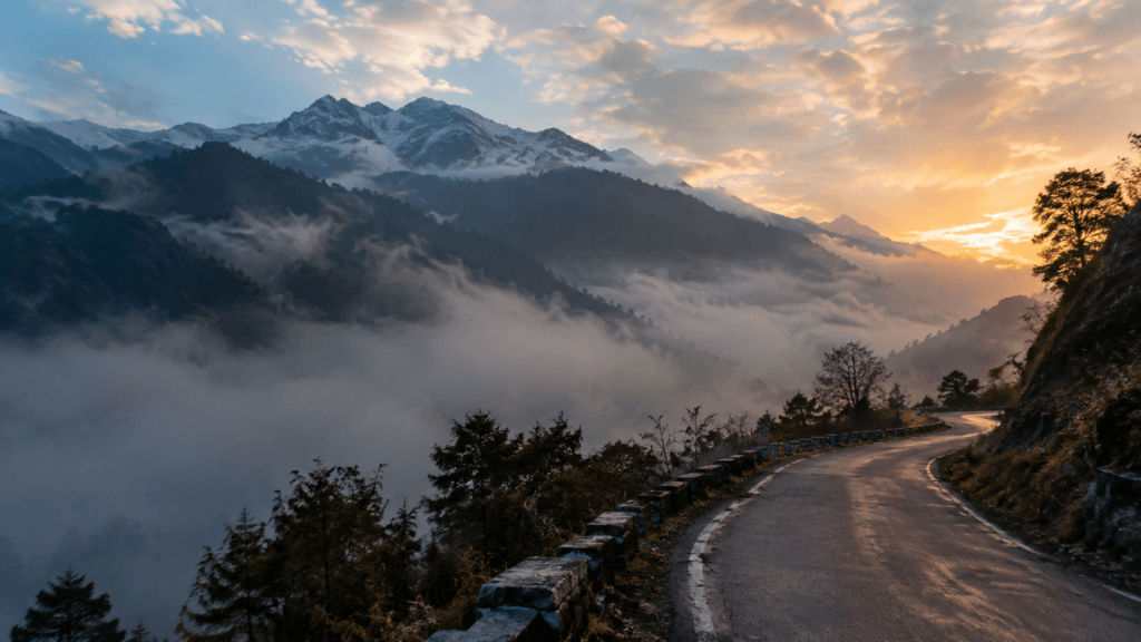 Tawang Arunachal Pradesh mountain landscape with a winding road and misty Himalayan mountains at sunrise